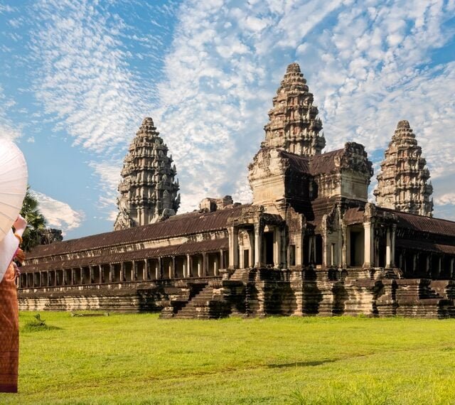 Unidentified young couple green traditional ceremonial wedding Khmer clothing at the ancient Angkor Wat temple - Cambodia.