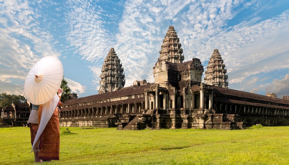 Unidentified young couple green traditional ceremonial wedding Khmer clothing at the ancient Angkor Wat temple - Cambodia.