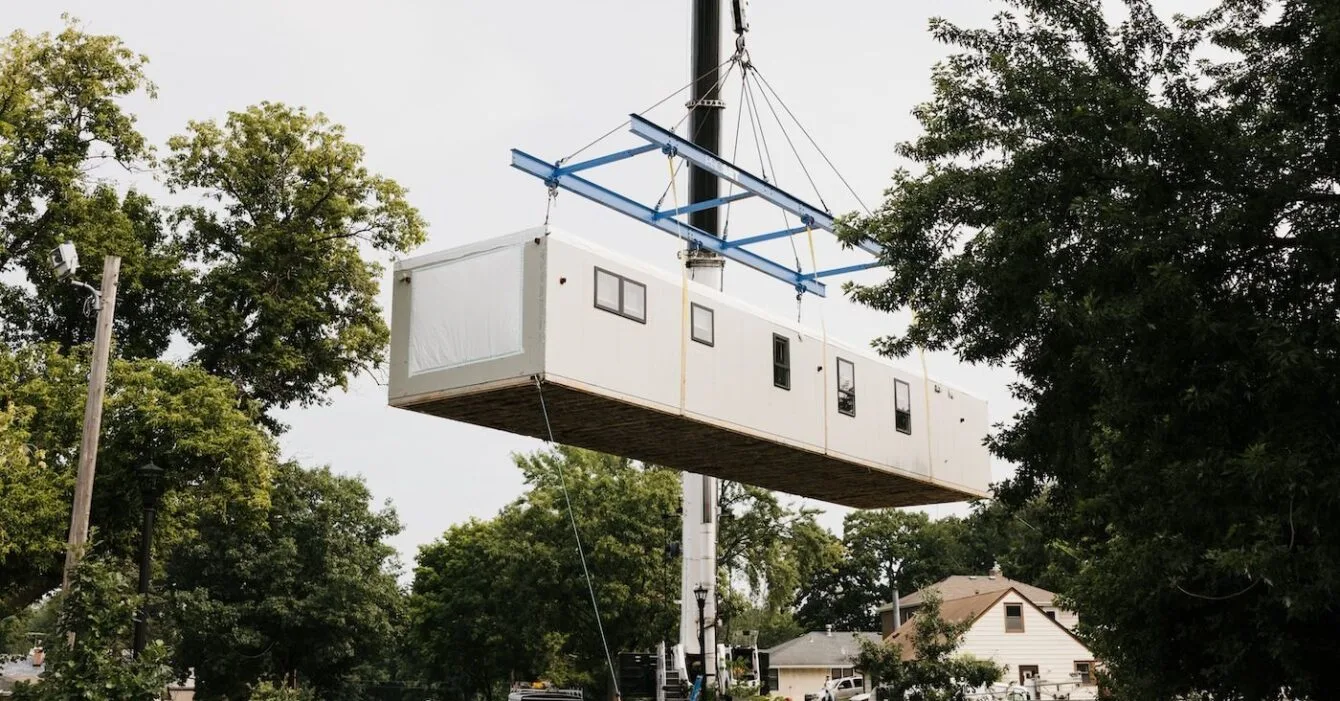 modular-cambodia A modular home section being lifted by a crane with workers overseeing the process, symbolising Modular Construction in Cambodia.