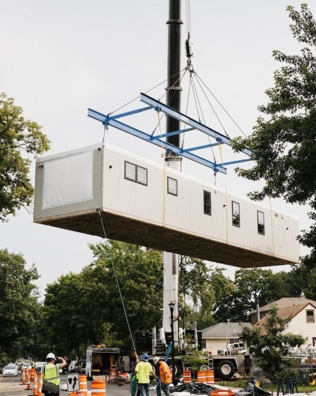 modular-cambodia A modular home section being lifted by a crane with workers overseeing the process, symbolising Modular Construction in Cambodia.