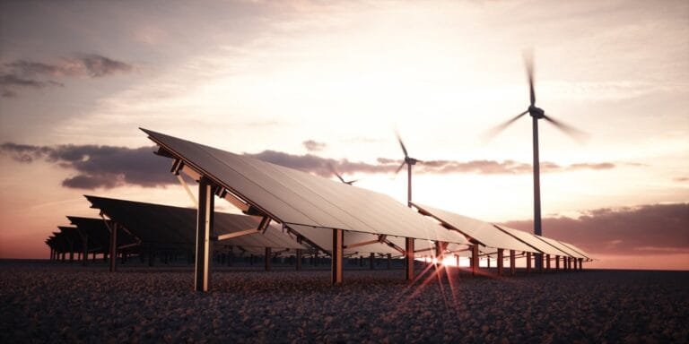Cambodia Renewable Energy Prospects: A solar panel array at sunset, with wind turbines in the background, emphasizing renewable energy and sustainability.