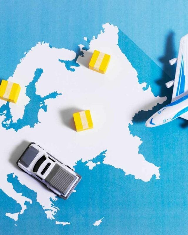 Cambodia Export Tariff Risk: A toy car and airplane are positioned on a stylized map of Europe with yellow boxes representing shipments.