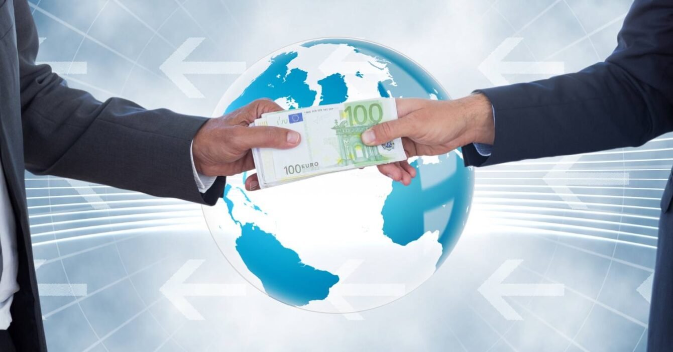 Cambodia Export Tariff Avoidance: Two businessmen hand over a €100 bill in front of a globe, symbolizing international financial transactions and global trade.