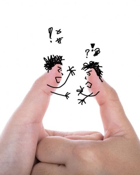 Cambodia Border Trade Tensions: Two fingers artfully drawn as angry characters facing each other, conveying a playful argument with speech bubbles and expressive gestures.