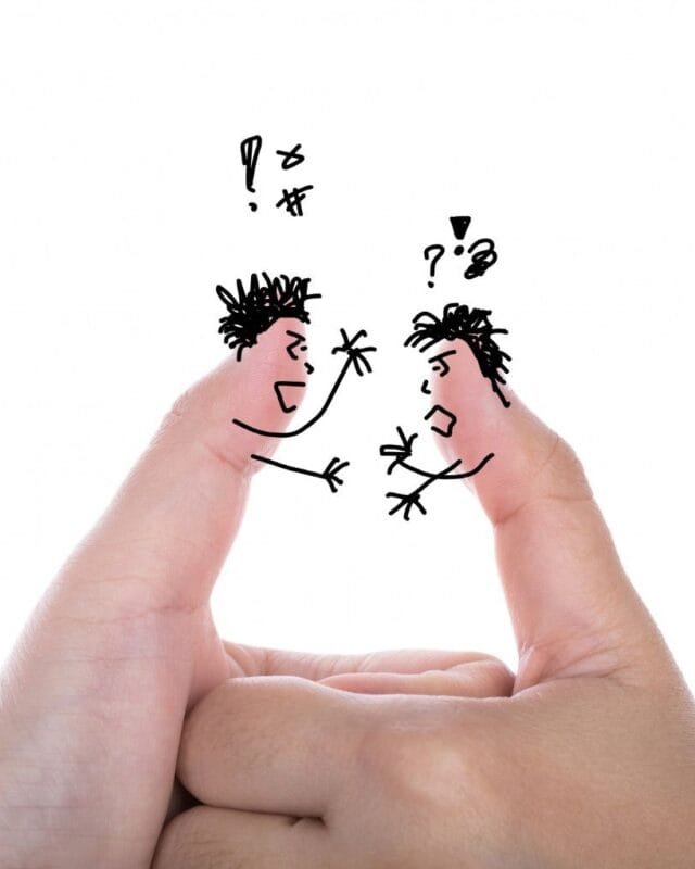 Cambodia Border Trade Tensions: Two fingers artfully drawn as angry characters facing each other, conveying a playful argument with speech bubbles and expressive gestures.