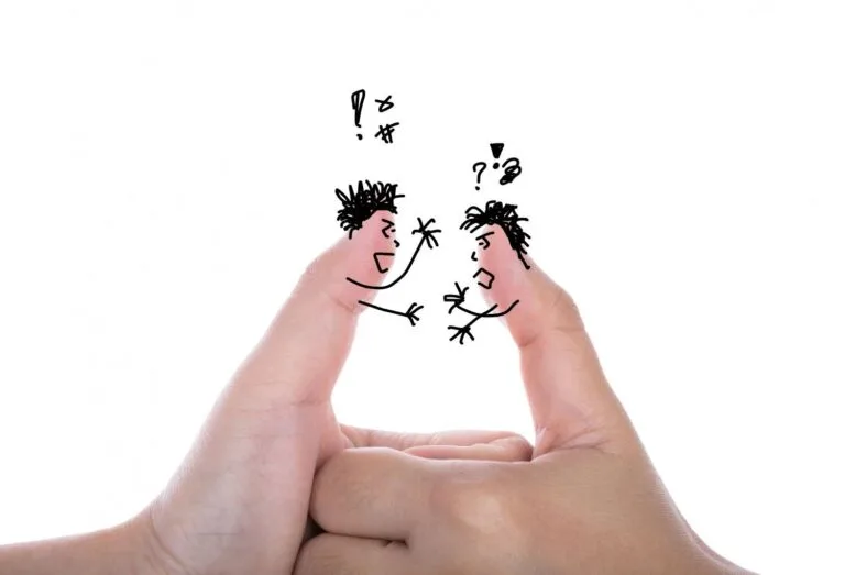 Cambodia Border Trade Tensions: Two fingers artfully drawn as angry characters facing each other, conveying a playful argument with speech bubbles and expressive gestures.